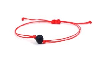 Red thread string bracelet with amber