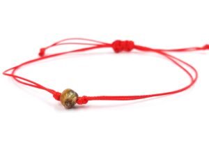 Red thread string bracelet with amber