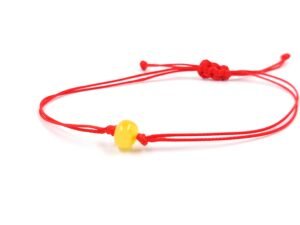 Red thread string bracelet with amber